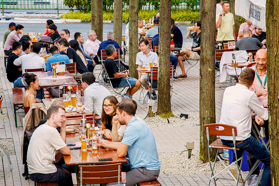 People enjoying lunch and beer outside Paulaner Brauhaus Singapore